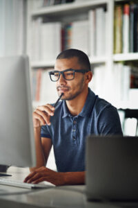 Cropped shot of a businessman using his computer in his home office